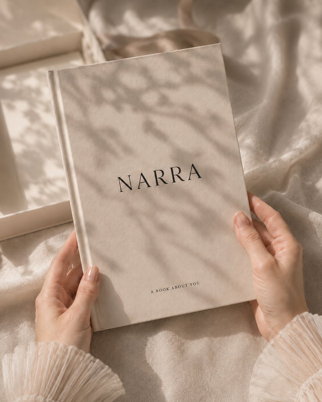 Персональная книга NARRA в руках, на обложке «a book about you»